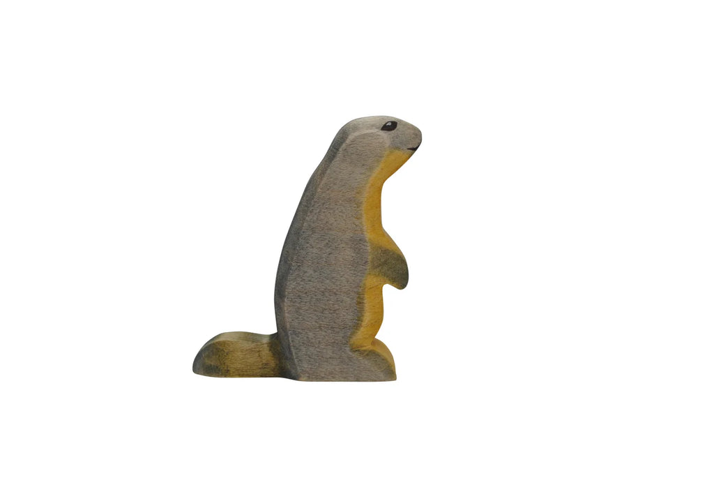 A high-quality wooden carving of a Handmade Holzwald Marmot standing upright, painted in muted brown and yellow tones, isolated on a white background.