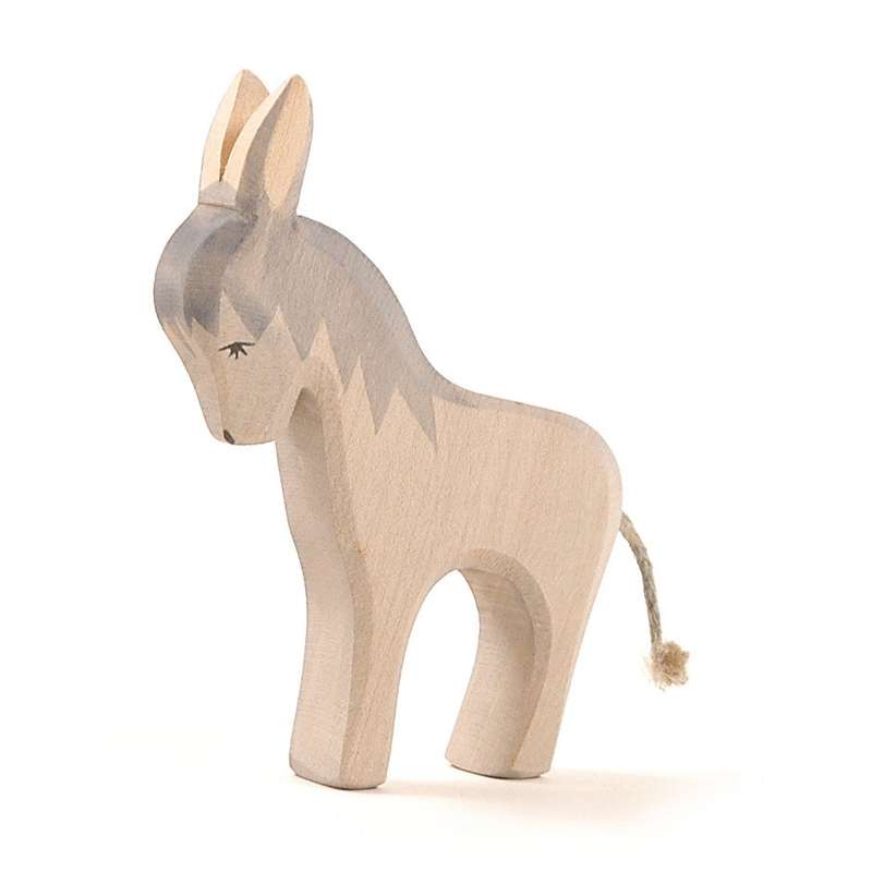 Sentence with product name: Handcrafted Ostheimer Donkey - Standing with a simple, stylized design, featuring a two-tone body in gray and natural wood colors, painted eyes, and a small rope tail, isolated on a white