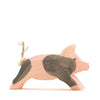 A handcrafted Ostheimer Spotted Piglet - Running figurine painted in shades of pink and gray, with a rustic twine loop on its back, against a white background.