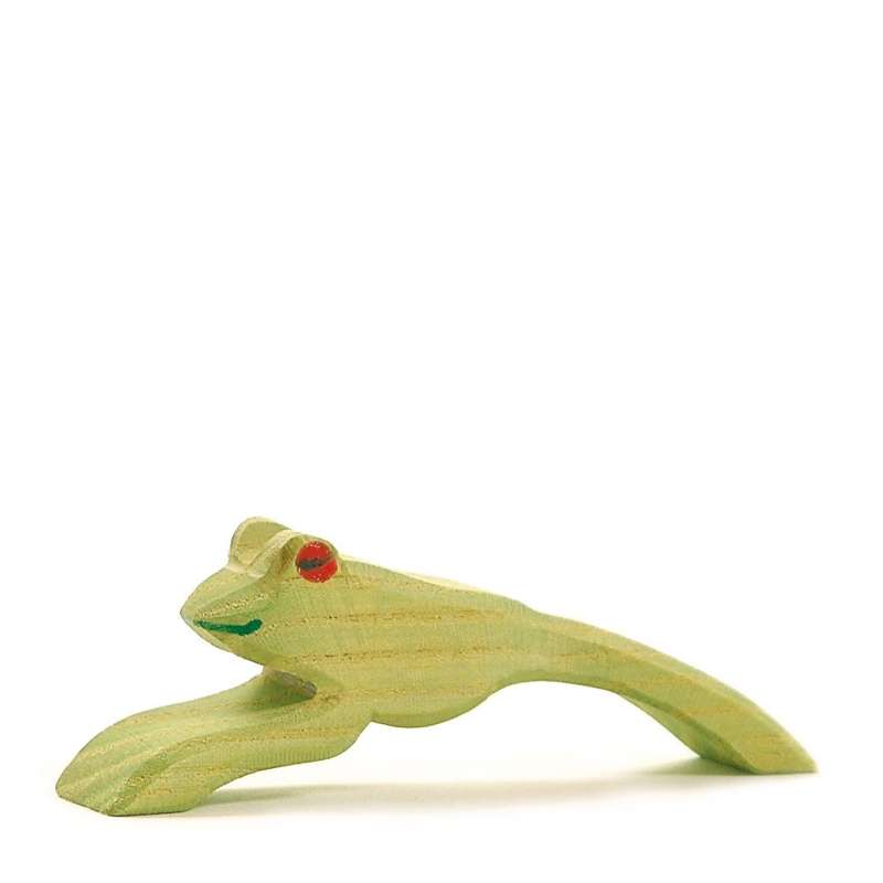 A handcrafted Ostheimer Jumping Frog figurine painted in light green, featuring red eyes, positioned diagonally on a plain white background.