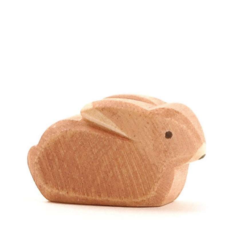 A small Ostheimer Small Rabbit figurine, crafted with simple shapes and smooth lines, featuring a natural wood finish and visible grain, isolated on a white background.