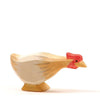 A small handcrafted Ostheimer Long Neck Hen - Ochre, painted in pale colors with hints of tan and red, standing profile against a plain white background.