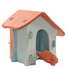 A blue wooden birdhouse with a red roof and red accents. The birdhouse has an arched entrance with a small ramp extending outwards. It features several small decorative knobs and a curved, whimsical design—ideal for imaginative play reminiscent of handcrafted wooden toys like the Ostheimer Hen House / Chicken Coop.