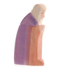 A Ostheimer Joseph depicting an elderly person, handcrafted in soft purple and pale pink tones, with a gentle and contemplative expression, isolated on a white background.