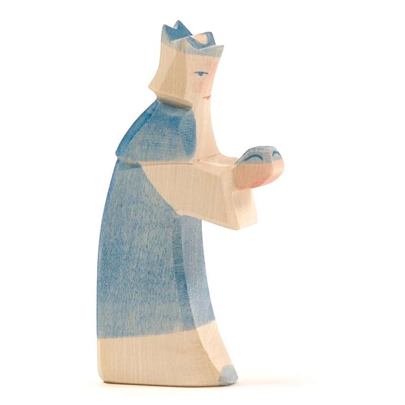 A handcrafted Ostheimer Blue King With Crown figurine, depicted in pastel blue with simplistic features, holding a small object tenderly in her arms, isolated on a white background.