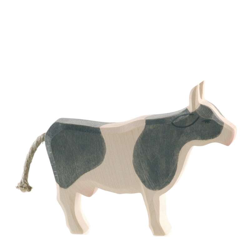 A handcrafted Ostheimer Cow - Black & White - Standing with a simplistic design, featuring natural wood colors and grey patches, standing against a plain white background.