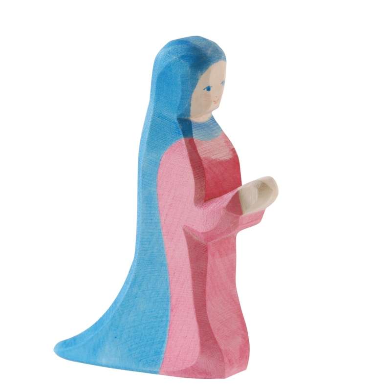 A handcrafted Ostheimer Mary - Standing figurine of a female character painted in blue and pink, depicted in a kneeling pose with her hands together in a gesture of prayer.