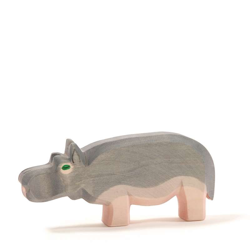 A Ostheimer Hippopotamus, painted in soft gray tones with a small green eye, standing against a white background.