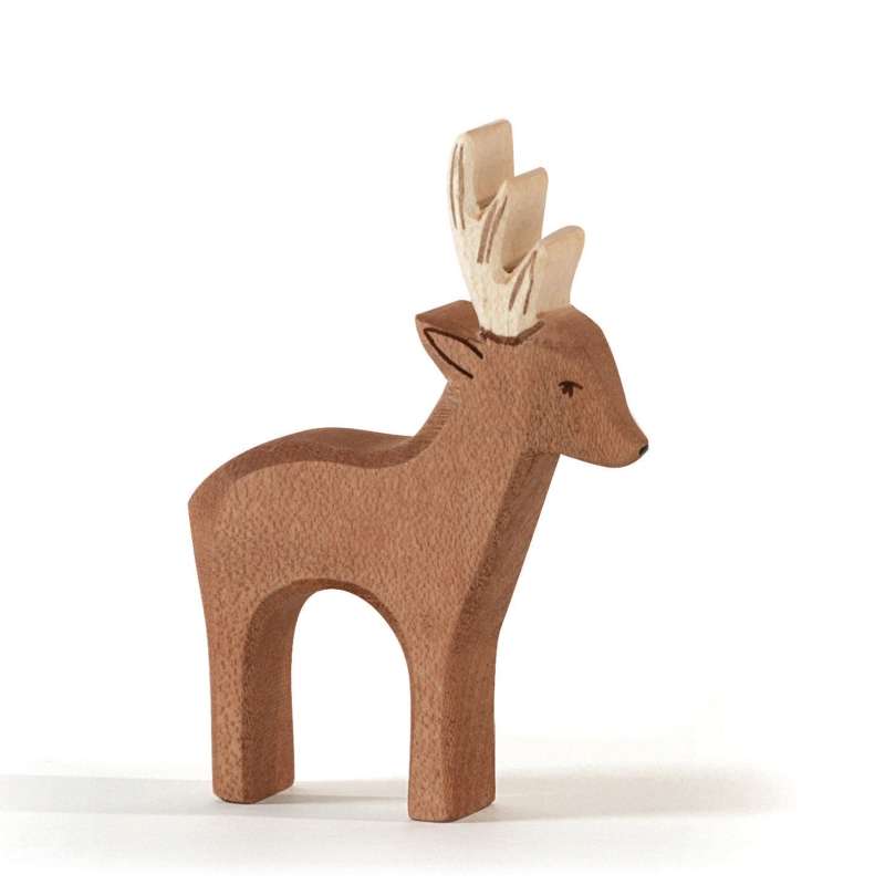 A small handcrafted Ostheimer Deer figurine with prominent antlers, depicted in a stylized form with smooth surfaces and soft edges, standing against a plain white background.