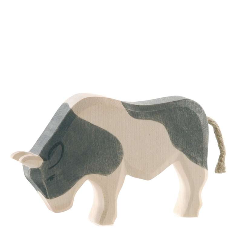A handcrafted Ostheimer Ox - Black & White, painted in white and gray patches, featuring a simple, stylized shape and a small rope tail, isolated on a white background.