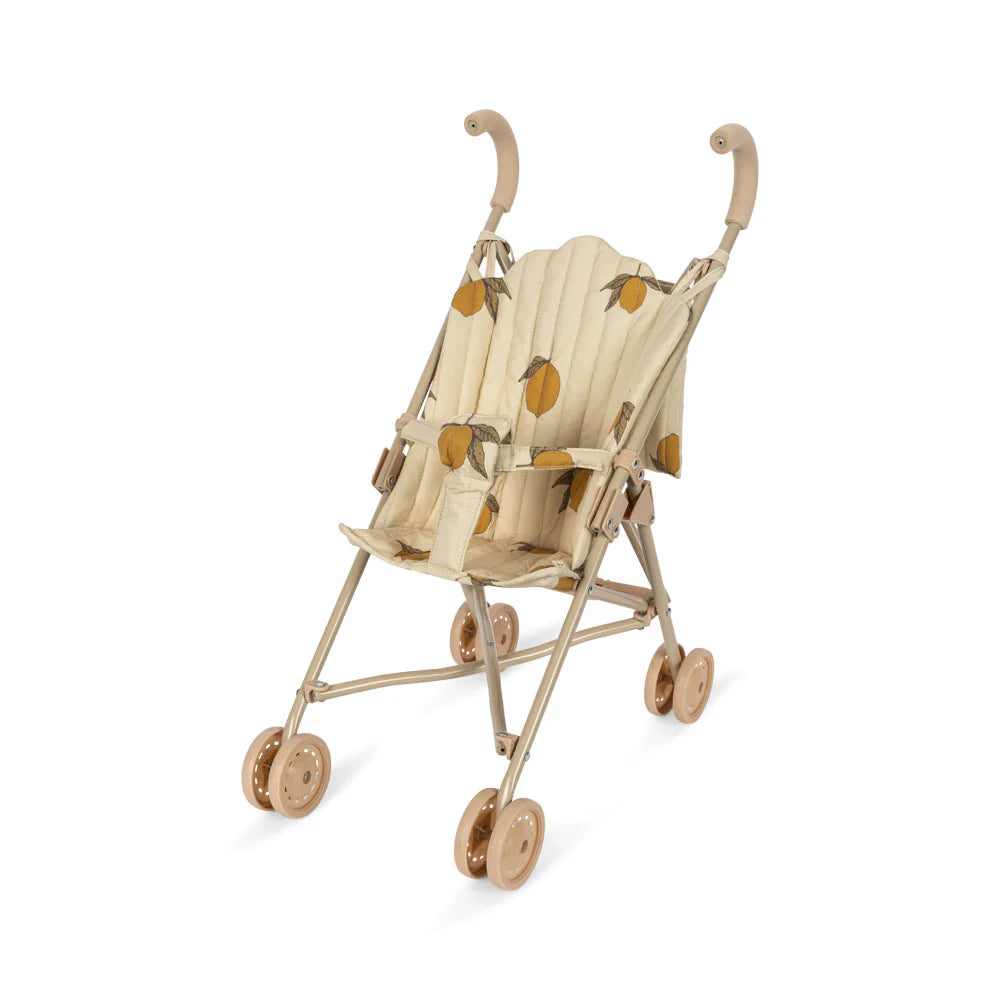 Introducing the Konges Sloejd Doll Stroller - Grand Lemon, a delightful beige and brown stroller featuring a lemon-patterned seat. This stroller offers removable fabric, elegantly curved handles, and four sets of double wheels for smooth and easy movement.