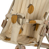 A close-up of the Konges Sloejd Doll Stroller - Grand Lemon showcases a beige fabric with a lemon pattern on the seat. The fabric features yellow lemons with green leaves, and it's quilted and removable for easy cleaning. The stroller is designed with double wheels for added stability and includes a strap, along with a metal frame in a neutral tone.