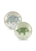 The Konges Sloejd - Glitter Bouncing Ball Set includes two clear balls, each with a dinosaur figure (stegosaurus and triceratops) inside. Filled with confetti, they sparkle beautifully when bounced.