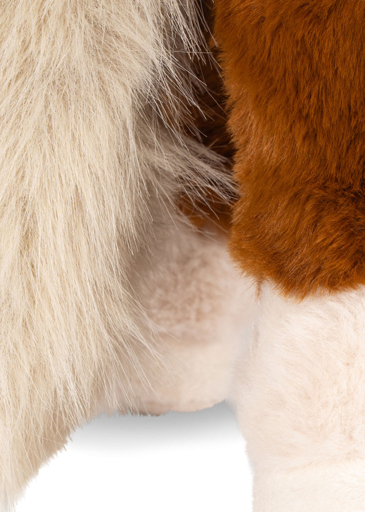 Close-up of a Konges Sloejd Fiona Horse toy featuring long, cream-colored faux fur next to short, brown and off-white patches of plush fabric.