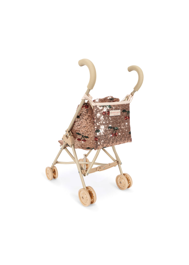 Konges Sloejd Sparkly Doll Stroller - Cherry Sequin with double wheels, rose gold sequins, a cherry pattern, and a tan frame.