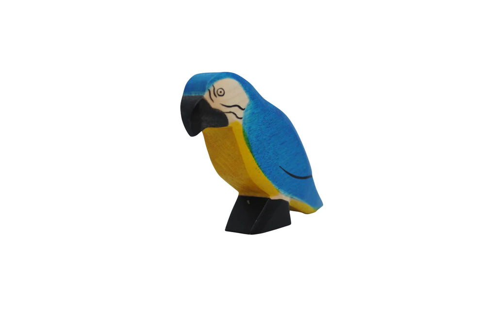 A Handmade Holzwald Blue Parrot figurine painted in vibrant blue and yellow colors, displayed on a black stand against a plain white background, is an example of sustainable toys.