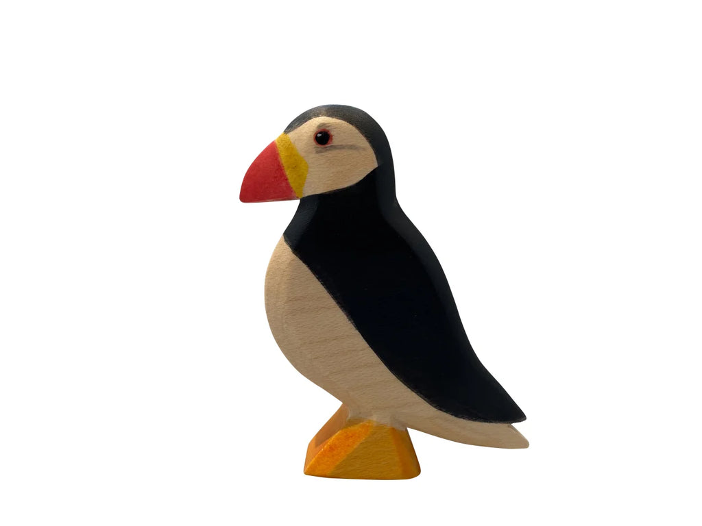 A Handmade Holzwald Puffin Bird figurine, painted in black, white, and yellow, standing upright on a flat base against a plain white background.
