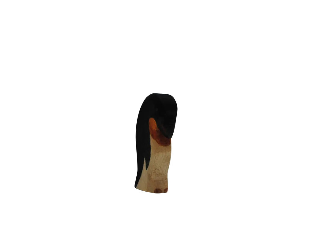 The Handmade Holzwald Penguin, Head Down, is a small, hand-carved wooden figurine with a black head, brown beak, and light body—an adorable sustainable toy for any collection. Photographed centered on a plain white background.