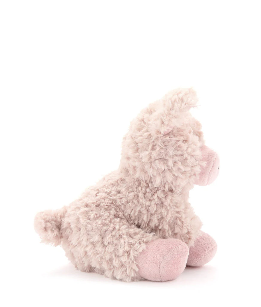 A plush, fluffy pig toy sits against a plain white background, reminiscent of a character from "Animal Farm." The pig is light beige with soft, textured fur and has small ears and a short tail. Its legs and face are slightly darker shades, enhancing its charming appeal. Meet Poppy the Pig!.
