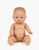 A Minikane Vintage Baby Doll (13") - Lily with a neutral expression sits upright on a plain white background, featuring a smooth surface, painted facial features, legs apart, and arms slightly reaching forward with a natural vanilla scent.