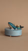 Wooden ocean themed music box with a blue whale in the center and a boat going around it. 