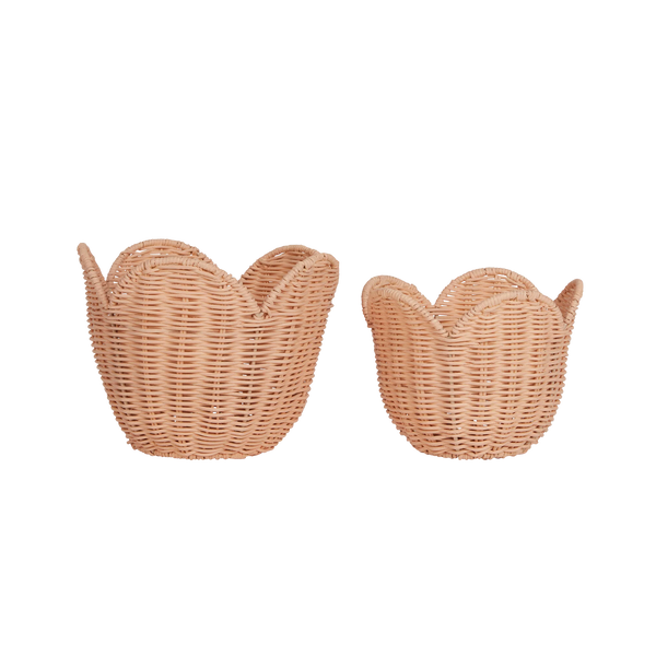 Two Olli Ella Rattan Lily Baskets designed to look like swans, facing opposite directions, displayed against a black background with horizontal white stripes.