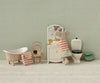 Experience bedtime charm with the Maileg Toothbrush Set in Bag, Mouse – Coral Stripe: a delightful accessory featuring a striped mouse and miniature toiletry essentials like a toothbrush, toothpaste, towel, and cup—all perfectly sized to complement your Maileg mouse family collection.