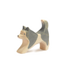 A small, handcrafted wooden figure of a sled dog in a running pose. The dog, with its sleek form capturing the essence of motion, showcases a simple and smooth design that highlights the natural grain and color of the wood. Perfect for imaginative play typical of Ostheimer wooden toys.