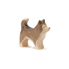 The Ostheimer Sled Dog - Standing is a handcrafted wooden figurine featuring a brown back and head, a light brown underbelly, and a curled tail. Its simplistic design with minimal facial details makes it perfect for imaginative play.