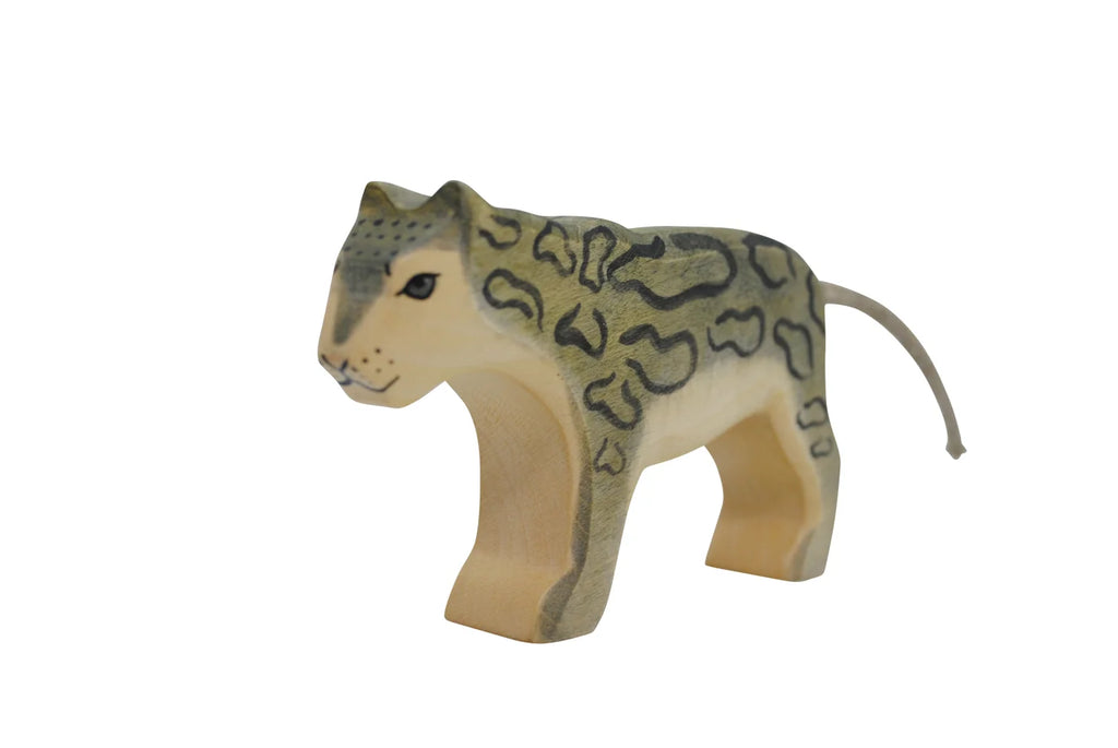 A handmade Holzwald Snow Leopard figure, painted with detailed patterns, stands isolated on a plain white background.
