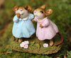 Two Wee Forest Folk Tiny Collectible - Funny Friends miniatures, hand-sculpted mice in blue and pink dresses, stand on moss holding hands, surrounded by tiny white and pink flowers. Not a toy; for collection display only.