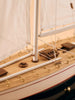 Close-up of the Little Forest Animals Silk Rug — The Regatta Series — The Endeavour, featuring a handcrafted sailing yacht deck with white sails, wooden planks, gold accents, detailed rigging, hatches, and nautical fixtures woven into the design.
