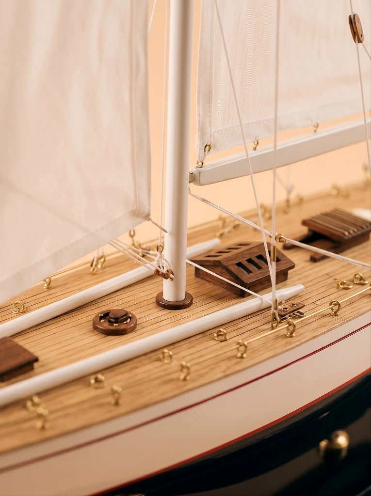 Close-up of the Little Forest Animals Silk Rug — The Regatta Series — The Endeavour, featuring a handcrafted sailing yacht deck with white sails, wooden planks, gold accents, detailed rigging, hatches, and nautical fixtures woven into the design.