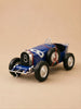 Introducing "Little Forest Animals — The Grand Prix": a blue vintage handcrafted die-cast car inspired by the iconic Bugatti Type 35, complete with large black tires, white rims, and the number eight on its grille—all beautifully set against a plain beige background.
