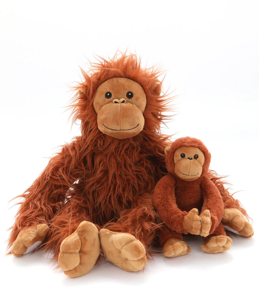 Two "The Orangutans Stuffed Animal" toys sit together against a white background, embodying a tender mother-daughter bond. The larger one boasts long, fuzzy orange fur and a cheerful expression, while the smaller one has shorter, smooth fur and is slightly curled up with a similar happy look.