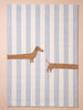 The Little Forest Animals Silk Rug — The Dachshund showcases a playful dachshund stretched across blue and white stripes, with its head and front legs on the left and its tail and back legs on the right—a charming hand-tufted silk rug that’s perfect for a children’s room.