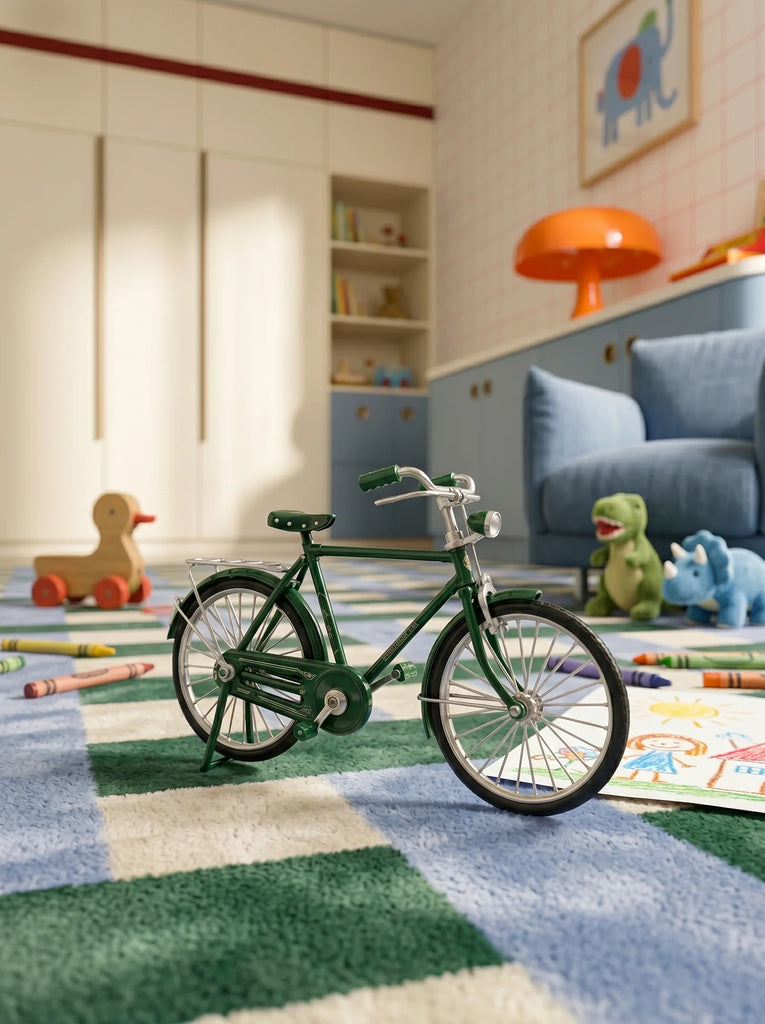 A green toy bicycle sits on The Weave's Little Forest Animals Silk Rug in a colorful children's room, surrounded by crayons, toy dinosaurs, a wooden duck, and scattered drawings, with shelves and a couch in the background.