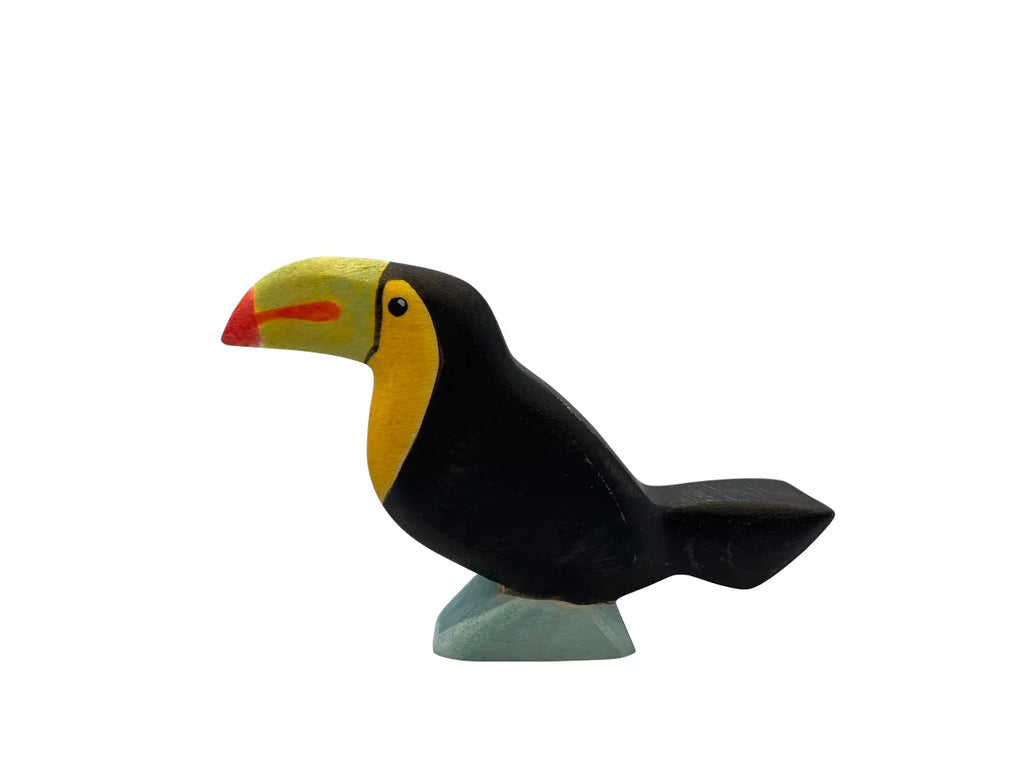 A high-quality Handmade Holzwald Toucan Bird statue with a yellow head, black body, and red beak, displayed against a plain white background.