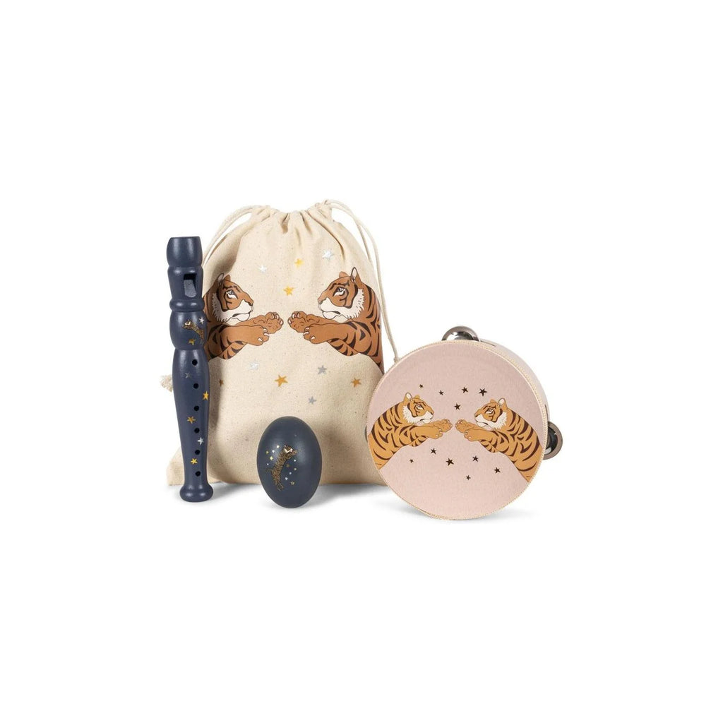 A Konges Sloejd Music Set Petite - Tiger containing a blue recorder, a blue egg shaker, and a light pink tambourine with tiger and star illustrations, displayed with a matching drawstring storage bag.