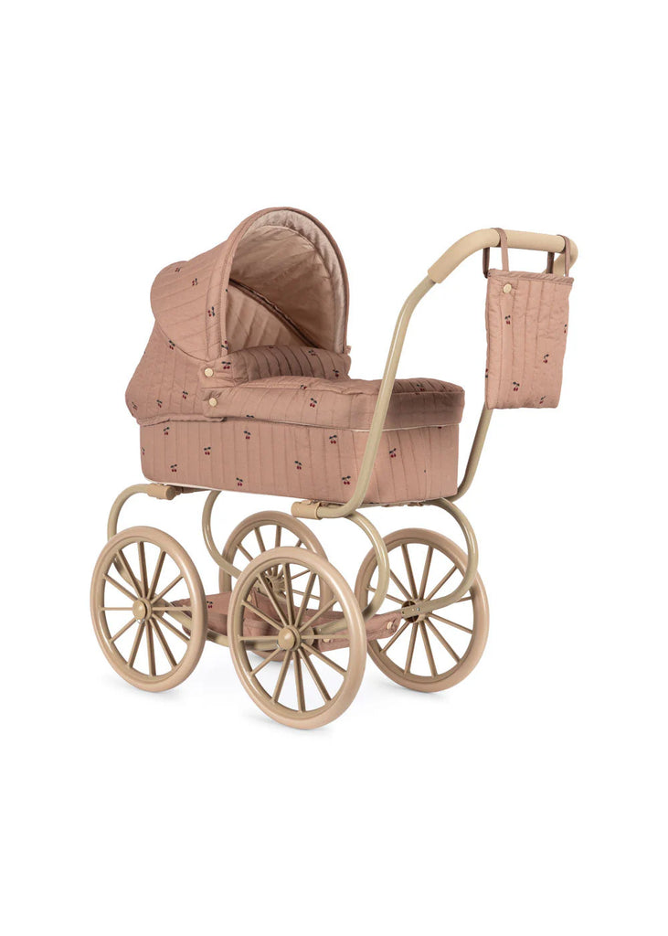 The Konges Sloejd Mini Doll Pram - Cherry Blush features pink quilted fabric, a beige metal frame, four spoked wheels, and a matching bag—an ideal toy pram or stroller for imaginative play.