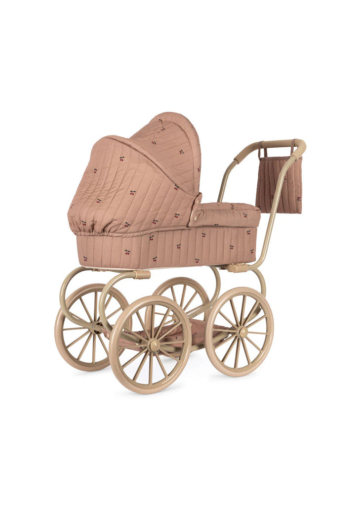 The Konges Sloejd Mini Doll Pram - Cherry Blush features a quilted dusty pink canopy and body, gold frame, four large spoked wheels, and a matching bag—perfect for little ones to stroll their dolls in style.