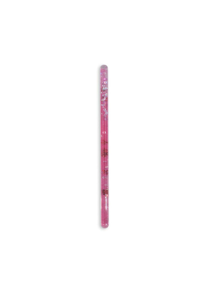 The Konges Sloejd Magical Glitter Wand - Pink Mix, filled with glitter and small decorations, resembling a magical pen, stands vertically on a plain white background.