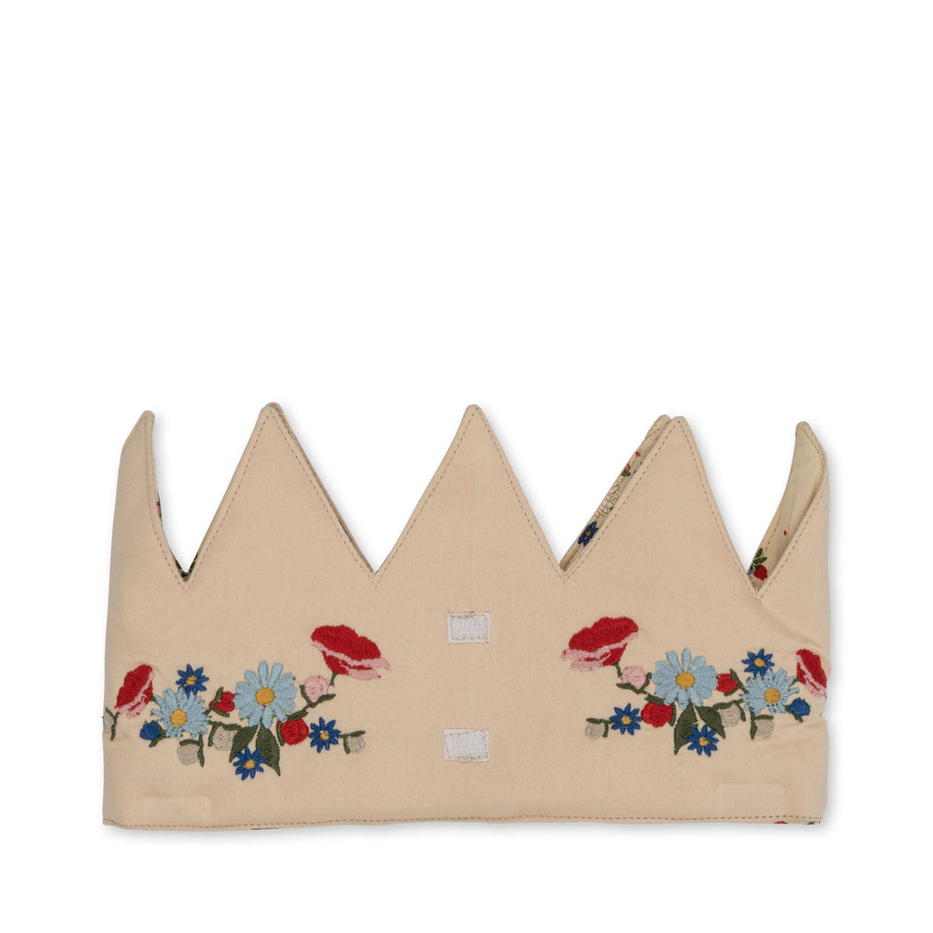 The Konges Sloejd Birthday Crown - Flower is a beige fabric crown with pointed tips, decorated with embroidered red, blue, and white flowers and green leaves along the base.