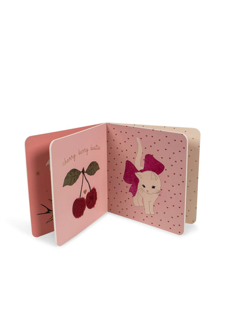 An open Konges Sloejd Touch and Feel Book - Unicorn displays colorful illustrations and touch-and-feel textures, perfect for babies to explore with their senses.