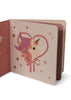The Konges Sloejd Touch and Feel Book - Unicorn features a pink unicorn with a rainbow mane inside a heart outline, surrounded by gold stars and polka dots—a delightful illustrated board book for babies.