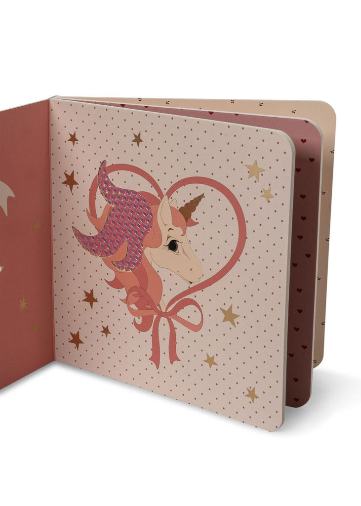 The Konges Sloejd Touch and Feel Book - Unicorn features a pink unicorn with a rainbow mane inside a heart outline, surrounded by gold stars and polka dots—a delightful illustrated board book for babies.