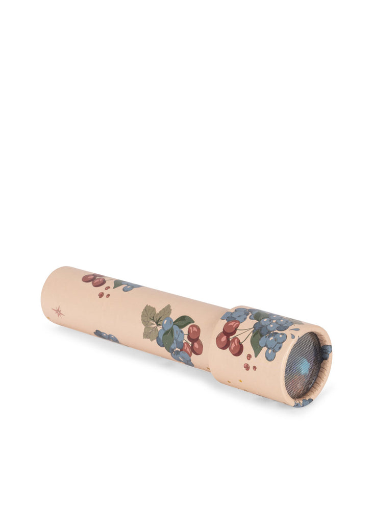 The Konges Sloejd Kaleidoscope - Cremona is a beige, FSC-certified cylindrical toy featuring illustrated grapes, cherries, and green leaves. It has a clear viewing lens on one end and is photographed on a white background.
