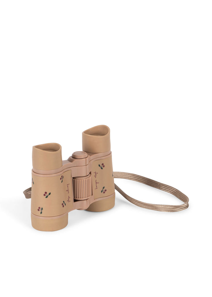Konges Sloejd Explorer Binoculars - Cherry: Tan binoculars with colorful cherry patterns, lightweight build, adjustable focus, and a tan carrying strap, shown against a plain white background.