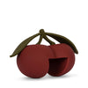 The Konges Sloejd Door Stopper - Cherry features two red cherries with green stems and leaves, one with a cut-out section. CE-tested and made from durable silicone, it’s both functional and decorative. Set against a plain white background.