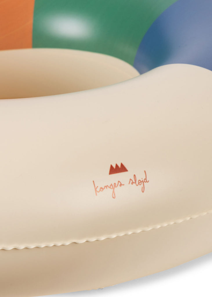 Close-up of the Konges Sloejd Junior Swim Ring in a multicolored design with green, orange, and blue sections.